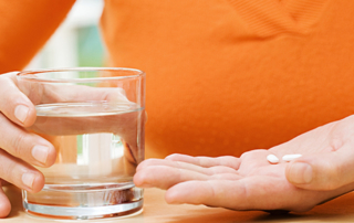 Woman with tablets and water