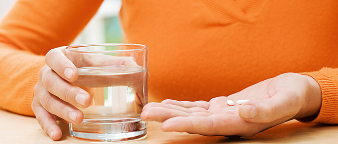 Woman with tablets and water